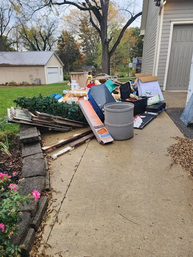 Dumpster being loaded with debris for Estate Cleanout Dumpster Rental in Windermere